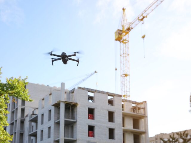 Survey drone flying above a building under construction